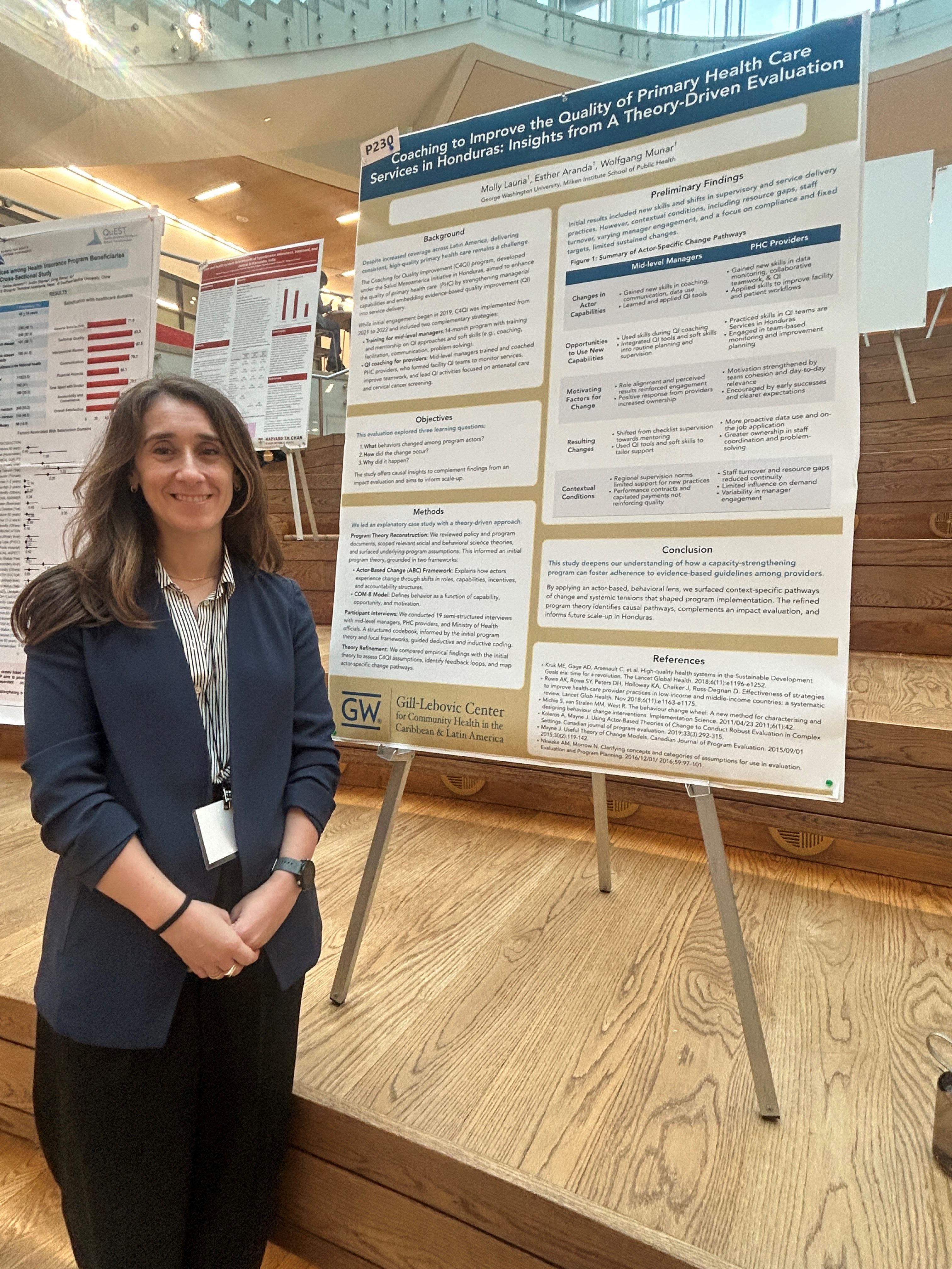 PhD Candidate standing in front of research poster 
